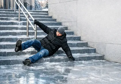 man slipping and falling down icy stairs