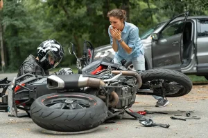 Woman approaching a motorcycleist she just hit