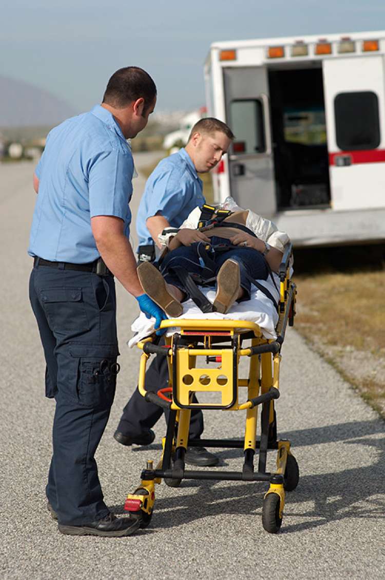 Woman being put in an ambulance after getting injured in a Denver car accident
